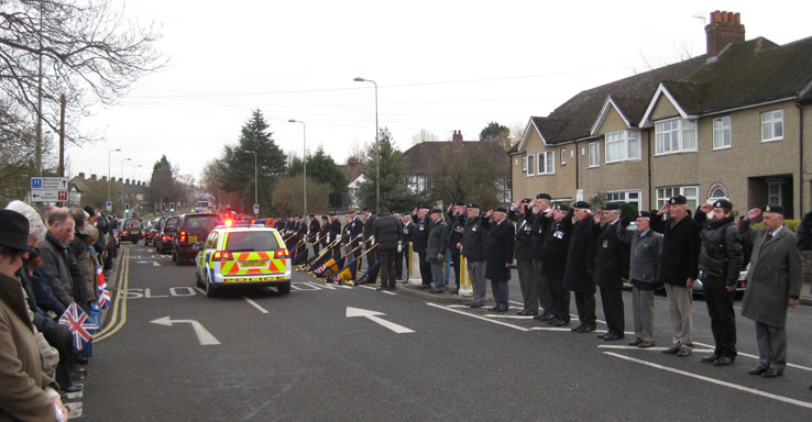 A police car brings up the rear